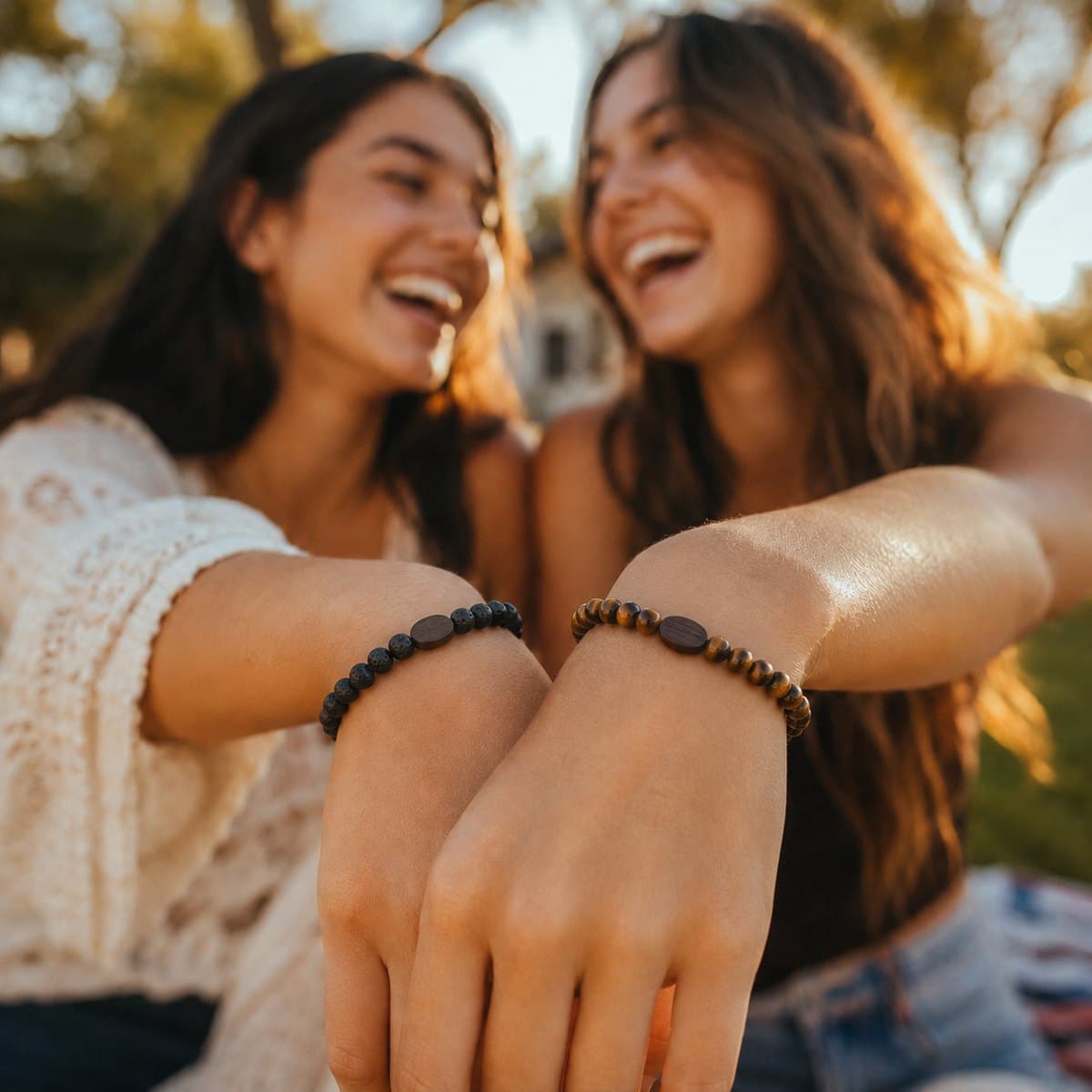 Two best friends laughing, holding their wrists together to show their EchoTap friendship bracelets